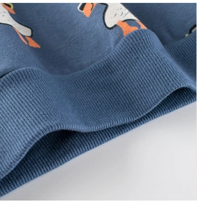 Detailed close-up of ribbed cuffs and soft cotton texture on kids duck print sweatshirt