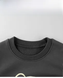 Detail of charcoal grey kids sweatshirt showing ribbed neckline and warm fleece lining