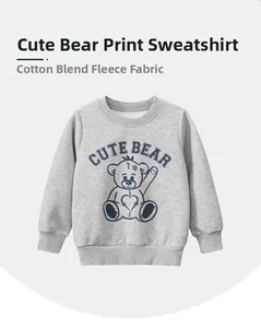 Detail of grey kids sweatshirt showing soft fleece lining and cute bear graphic print