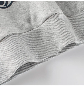 Detail of grey fleece sweatshirt showing ribbed hem and high-quality cotton fabric texture