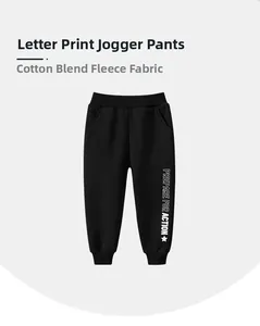 Detail of fleece-lined cotton blend kids jogger pants with white action letter print