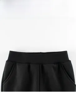 Detail view of children's fleece joggers with elastic ribbed waistband and side pockets