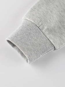 Close-up of heather grey fleece sweatshirt with ribbed cuffs and cotton knit fabric