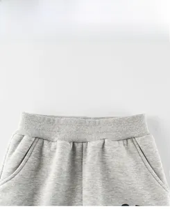 Detail of gray kids joggers showing the elastic ribbed waistband and side pockets
