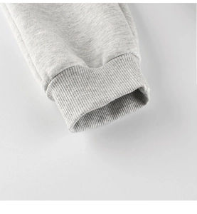 Detail of light grey ribbed cuffs on kids joggers showing high-quality cotton knit texture