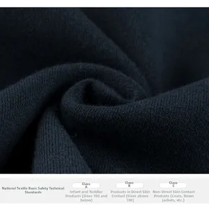 Detailed fabric macro showing textile safety standards for blue fleece sweatshirt