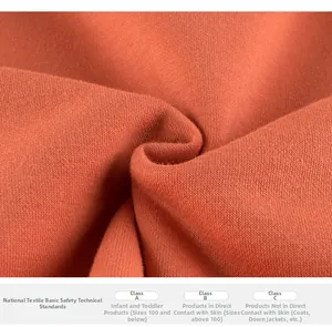 Macro del tessuto a maglia arancione ruggine con trama e standard di sicurezza tessile