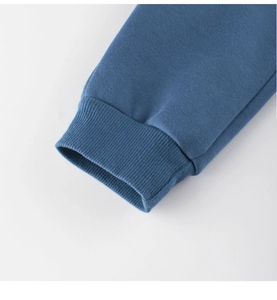 Primer plano detallado de los puños elásticos acanalados en el pantalón deportivo azul