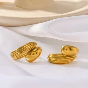 Polished 18K gold plated C-shaped earrings with ribbed texture on white satin