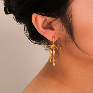 Elegant 18K gold-plated stainless steel bow earrings with zircon stones on model