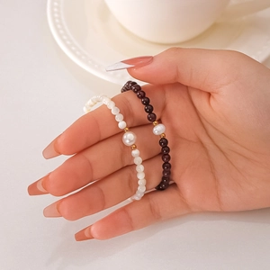 18K gold plated stainless steel bead bracelet with natural pearl on woman's wrist