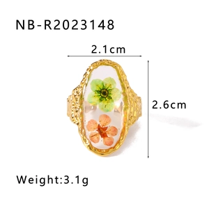 Dettaglio dell'anello ovale in acciaio inossidabile dorato con veri fiori essiccati
