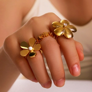 Golden flower ring set with pearls and zircons on model hand adjustable design
