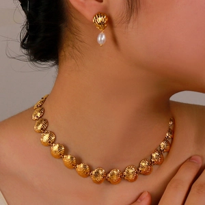 Elegant gold scallop shell jewelry set with natural pearls including necklace and earrings