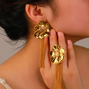 Vintage oversized gold flower earrings with long chain fringe on female model