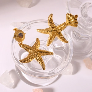 Gold starfish earrings with seashell inlay and textured 18K gold finish for women