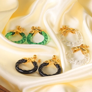 Three pairs of resin hoop earrings in green, clear, and black with 18K gold stainless steel