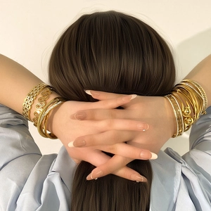 Stackable gold stainless steel bracelets with hollow texture and rhinestones for women