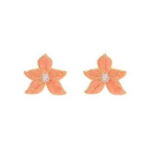 Detailed macro view of starfish earrings featuring coral enamel and drop-shaped zircon