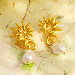 Elegant 18K gold-plated seahorse earrings with baroque pearls on textured background