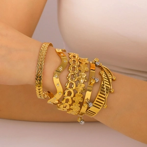 Golden stackable bracelet set featuring wheat chain, diamond waves and bead charms