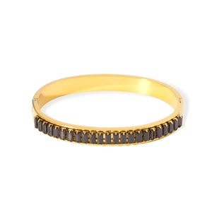 Gold stainless steel bangle featuring inlaid rectangular black stones and vintage aesthetic