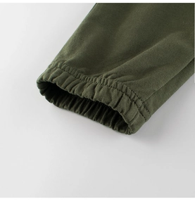 Macro detail of olive green kids sports pants showing the elastic ribbed ankle cuff