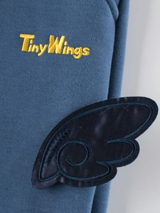 Detalles de sudadera azul para niños con bordado amarillo TinyWings y parche de ala