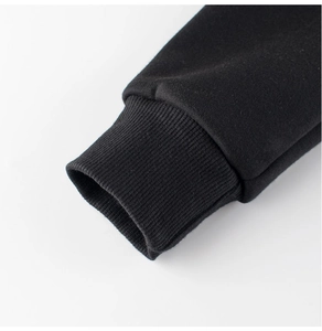 Close-up of ribbed knit cuffs on black long-sleeve fleece hoodie for boys