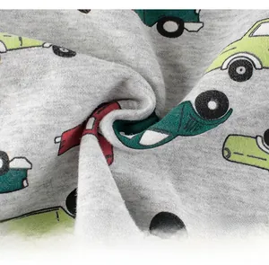 Detailed close-up of soft grey knit fabric with colorful cartoon car prints for kids