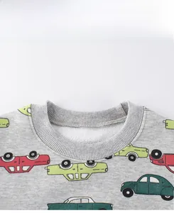 Close-up of the grey crewneck sweatshirt neckline featuring colorful cartoon car patterns