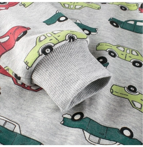 Detail of ribbed cuffs on gray fleece sweatshirt with colorful cartoon car prints