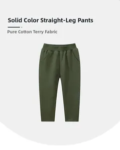 Detail view of dark green kids cotton joggers with elastic waist and side pockets