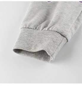 Close-up of grey heather knit fabric with elastic ribbed cuffs on sporty children pants
