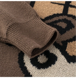 Close-up of the thick ribbed cuff and panda pattern on a warm knitted sweater