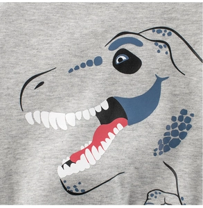Close-up of grey cotton knit fabric featuring a cute cartoon dinosaur print for kids