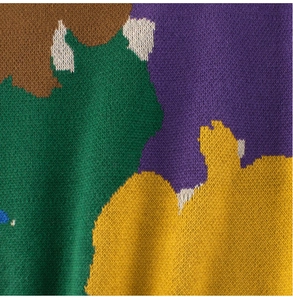 Close-up of multicolor knit texture on kids sweater featuring abstract geometric blocks