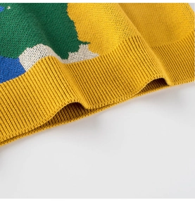 Detailed close-up of multi-color block knit sweater with ribbed hem and fine stitching