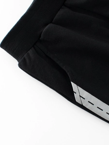 Pantalon de sport noir pour enfant avec taille élastique et poches à bandes réfléchissantes