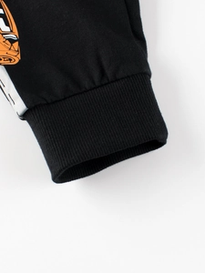 Pantalon de sport noir pour enfants avec poignets côtelés et imprimé orange
