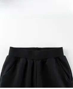 Detail view of the high-elastic waistband and pockets on black cotton boys' sports joggers