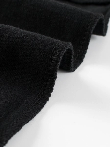 Detailed view of boys black fleece sweatpants showing thick fabric and neat stitching