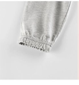 Detail of light heather grey elastic ribbed cuffs on children's cotton sports trousers