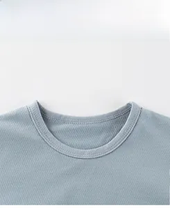 Macro detail of breathable honeycomb mesh fabric and reinforced crew neck of kids t-shirt