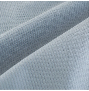 Macro shot of soft light blue twill cotton fabric texture showing fine weave patterns