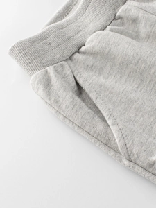 Children's grey sports pants with elastic waistband and side pockets close-up view