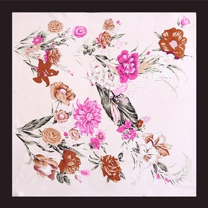 Detail of light pink silk scarf featuring realistic ink floral prints and black borders