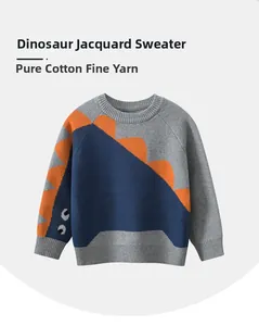 Detail of grey knitted sweater showing the dinosaur pattern and cotton texture