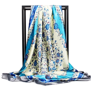 Blue floral satin silk scarf draped on black stand with baroque pattern 90cm