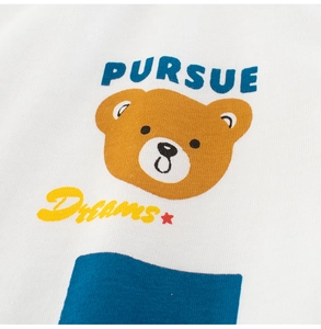 Close-up of a cartoon bear with Pursue Dreams text on a white cotton kids T-shirt